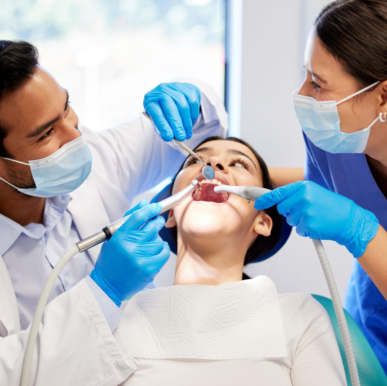 Dentist and dental assistant caring for a patient