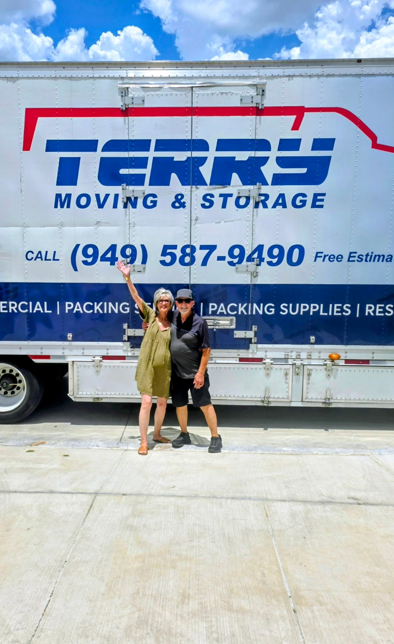 Terry Moving and Storage truck with two people standing in front